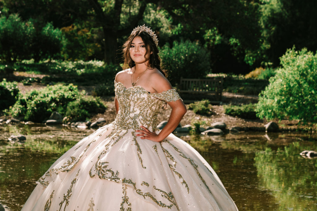 Quinceanera posing by water